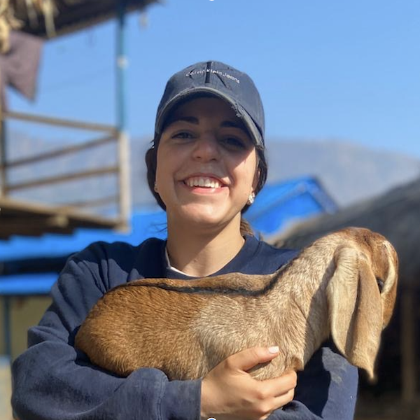 Savannah Ferretti holding a goat in Peru